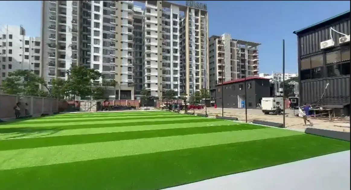 The new striped artificial pitch at Goal House, Bashundhara, with apartment blocks behind